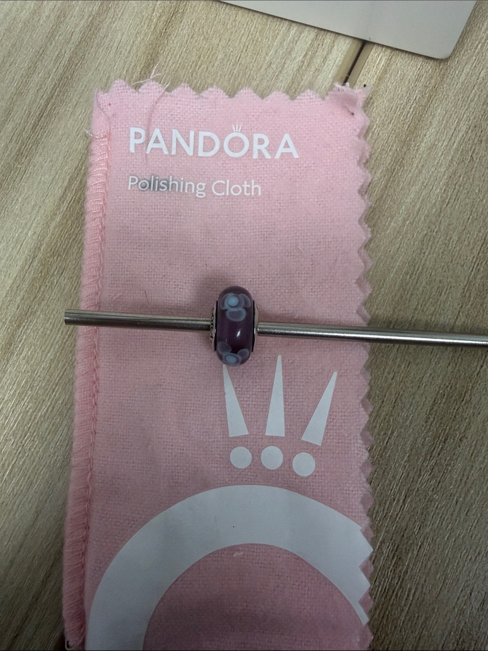 Pandora Murano glass bead purple with blue flowers.